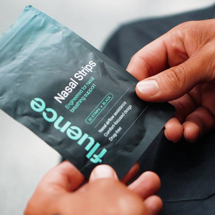 Athlete holding Fluence nasal strips packaging