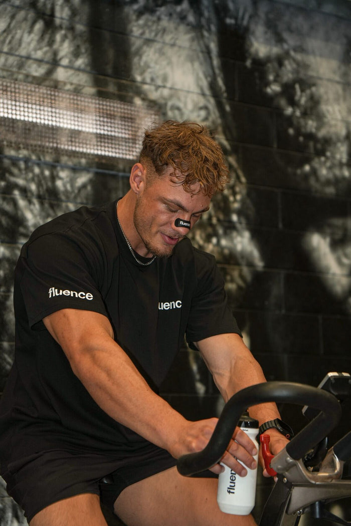 Athlete training with Base 250 mixed in a Fluence drink bottle