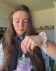 A customer makes up a glass of Base 250 Berry and tastes it