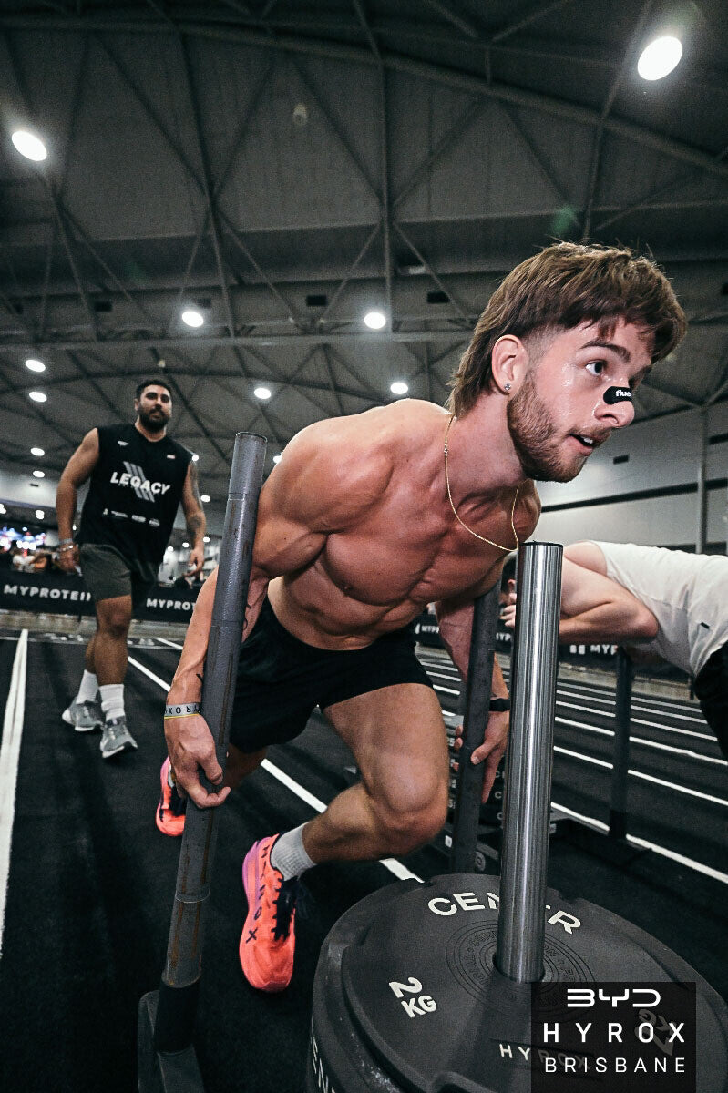 Athlete wearing Fluence Nasal Strip during HYROX sled push